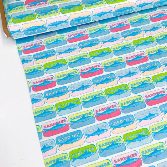 Bolt of quilting cotton with colorful pop-art style sardine tin pattern on a white background