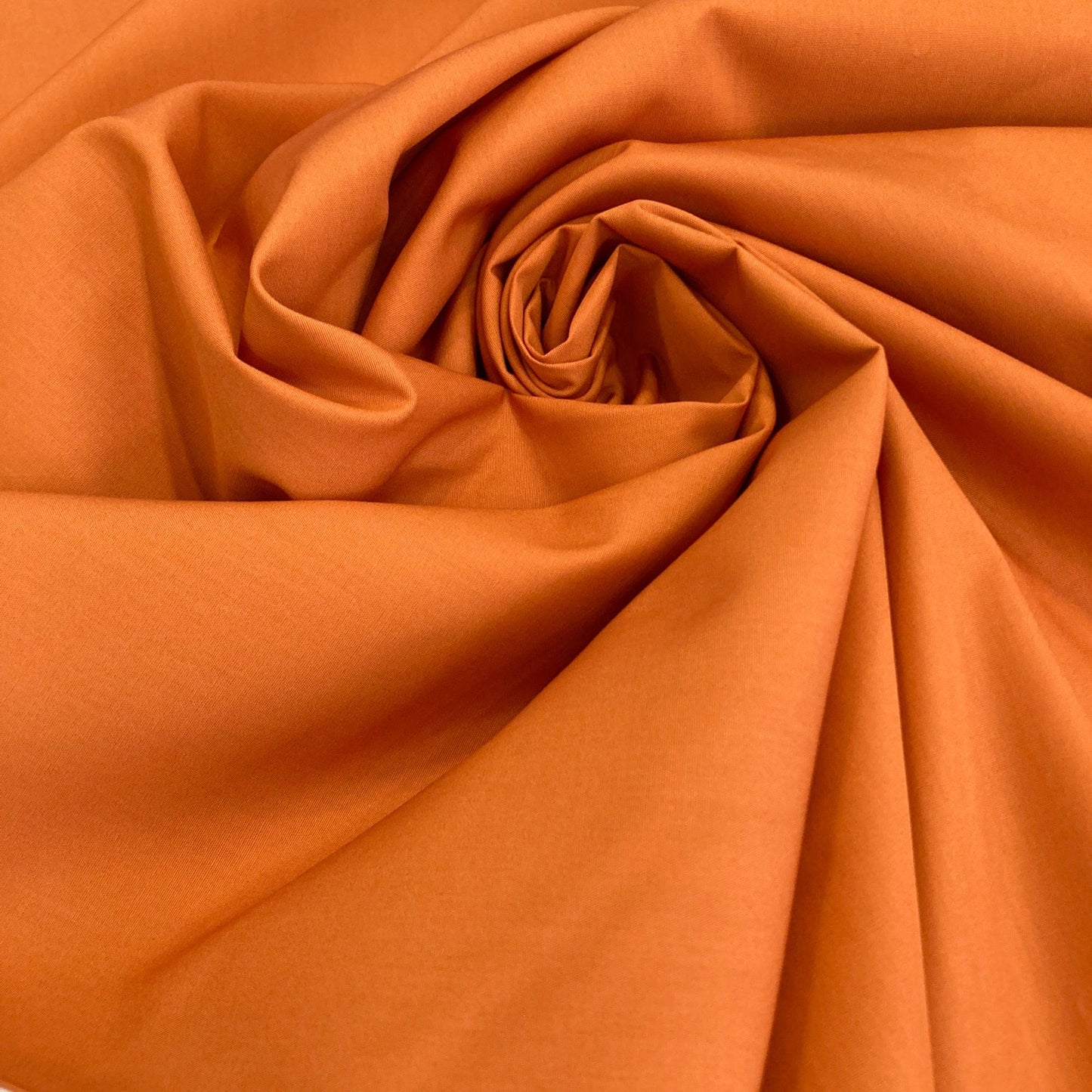 Close-up of Art Gallery Fabrics burnt orange quilting cotton solid