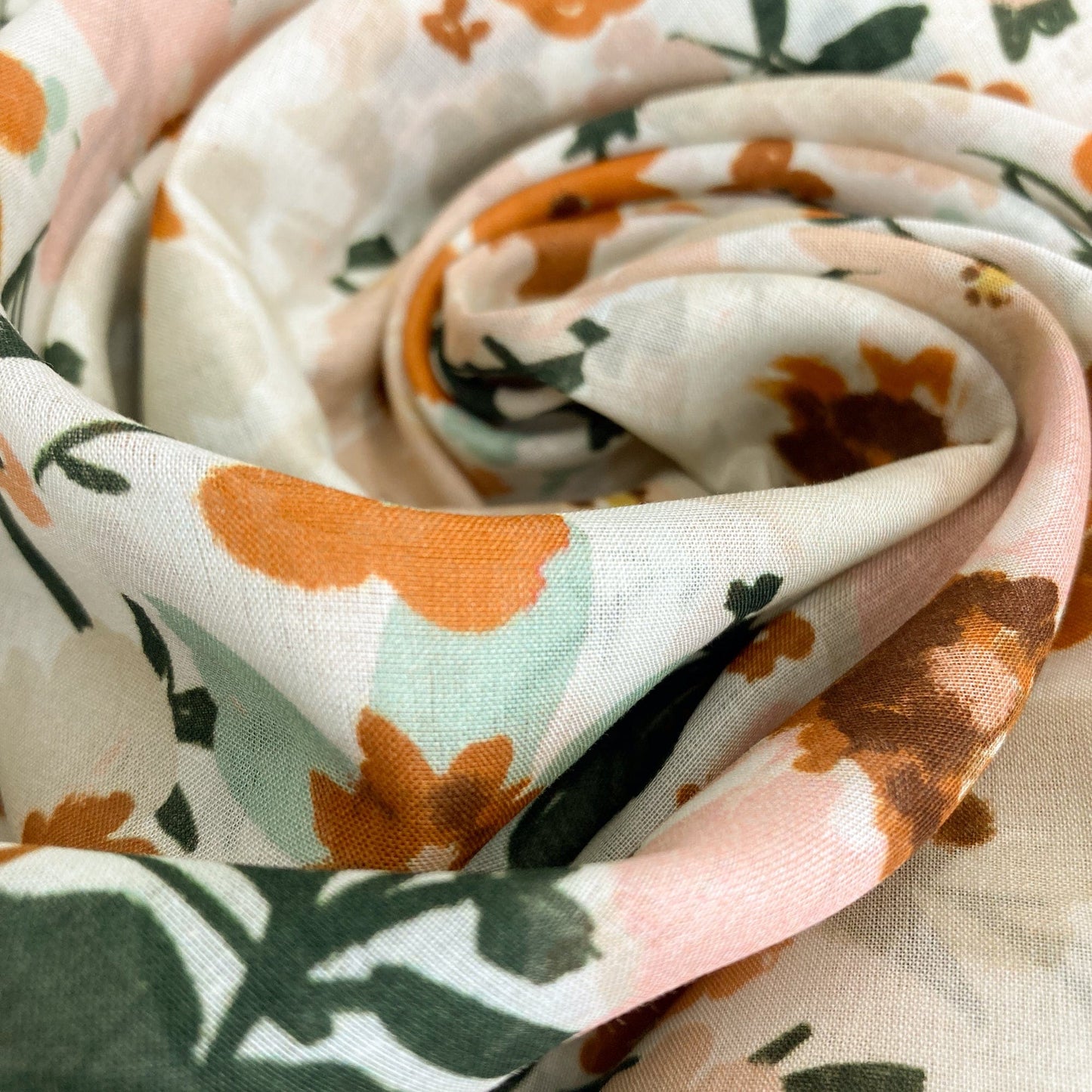 Close-up of a floral-patterned organic cotton batiste by Cloud 9 Fabrics
