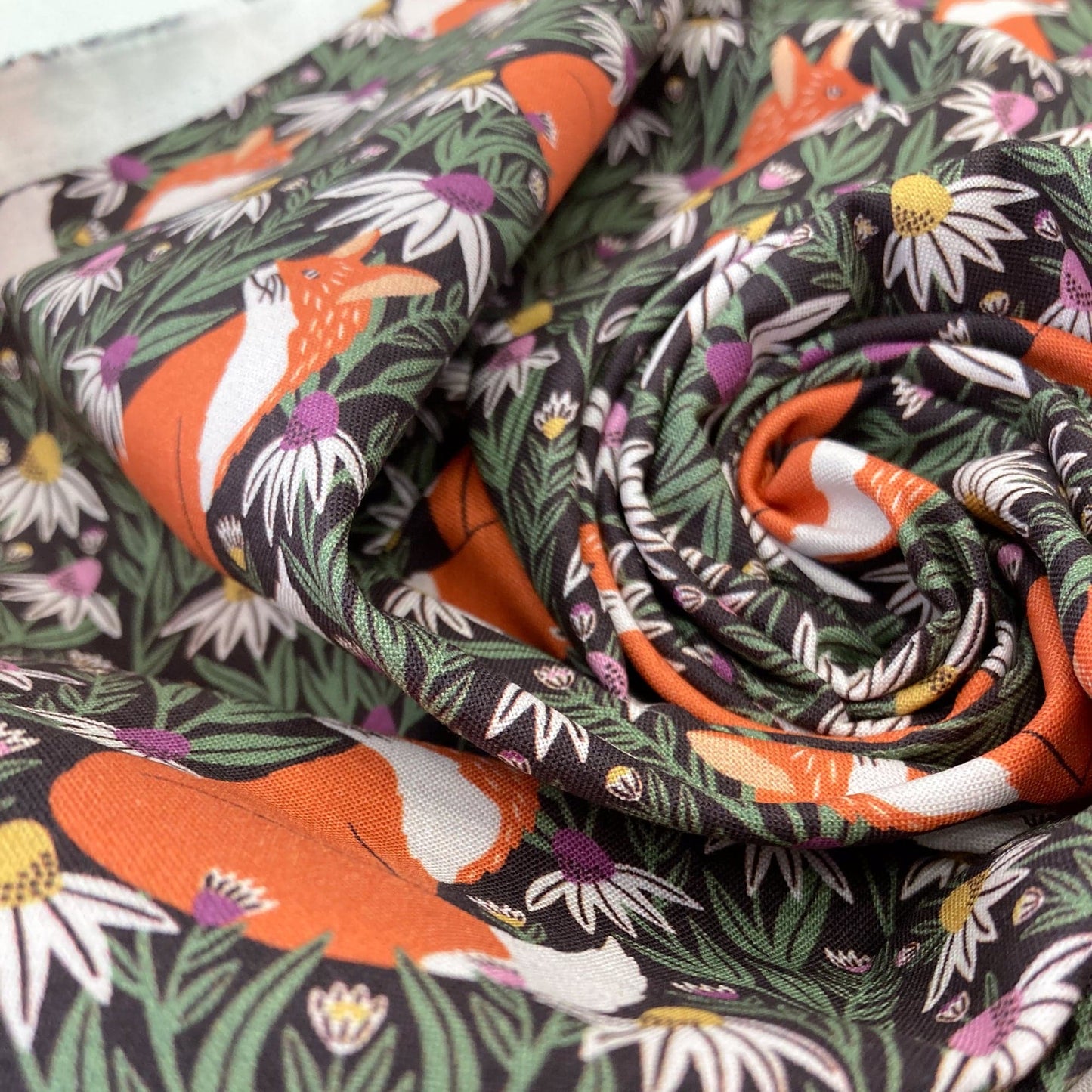 Swirl of organic quilting cotton with fox and floral pattern.