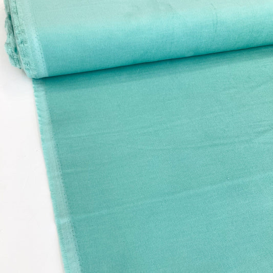 Bolt of turquoise cotton needlecord fabric
