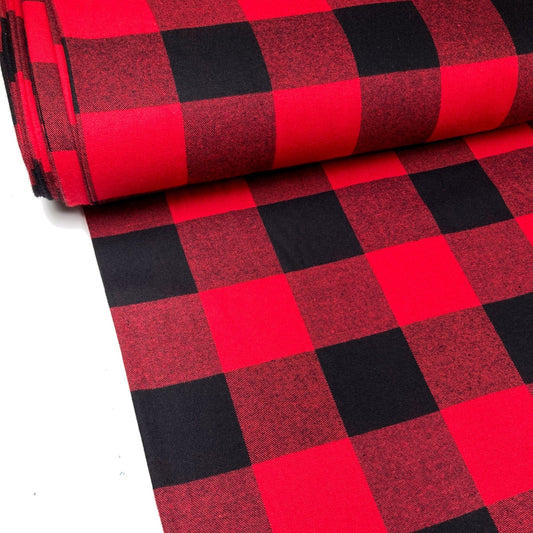 Bolt of red and black buffalo check flannel fabric on a white background