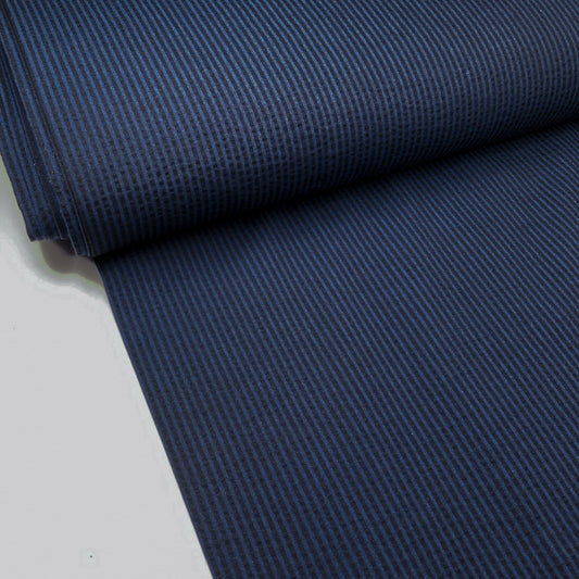 Bolt of dark blue cotton seersucker striped fabric