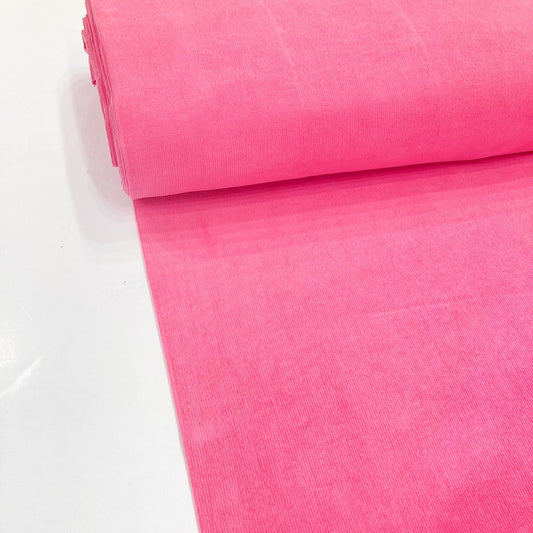 Bolt of bright pink cotton corduroy fabric