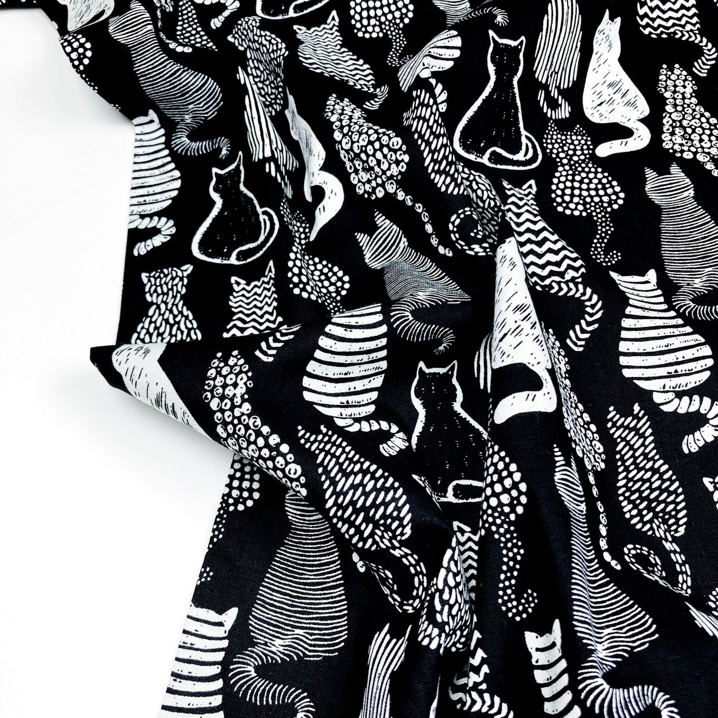 Cotton Fabric with a graphic style cat print in black and white.