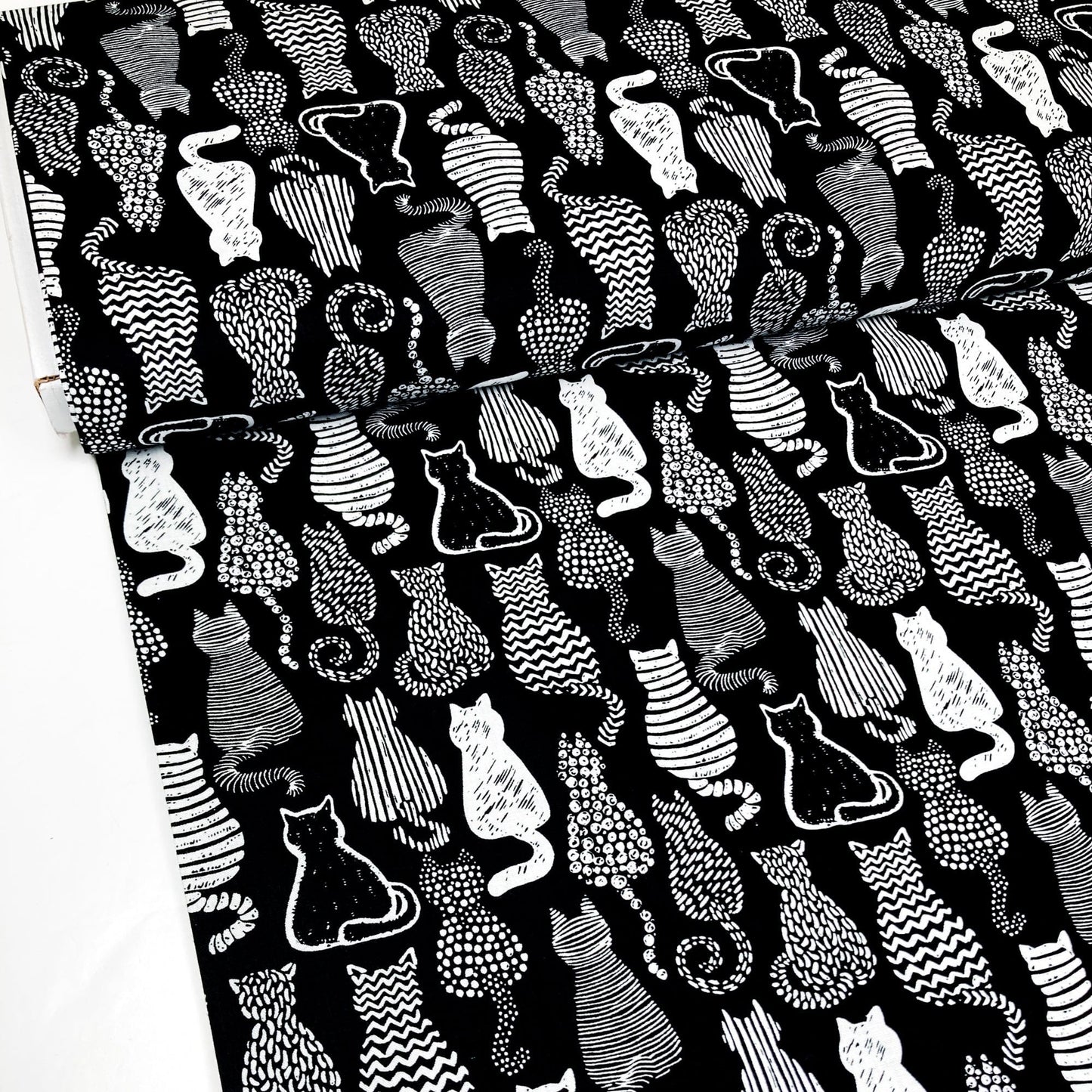 Cotton Fabric with a graphic style cat print in black and white.