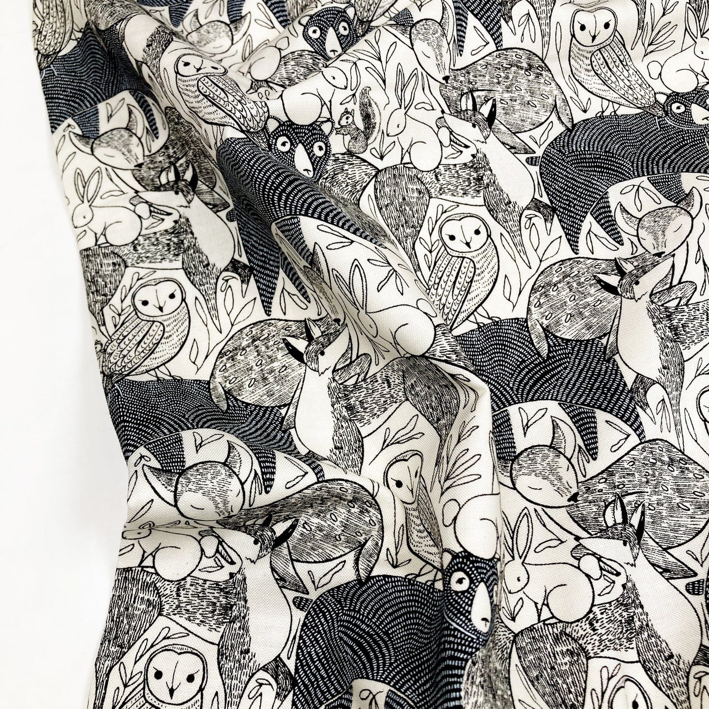 Black and white patterned cotton fabric with animal illustrations