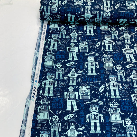 Bolt of quilting cotton fabric with robot pattern on a blue background
