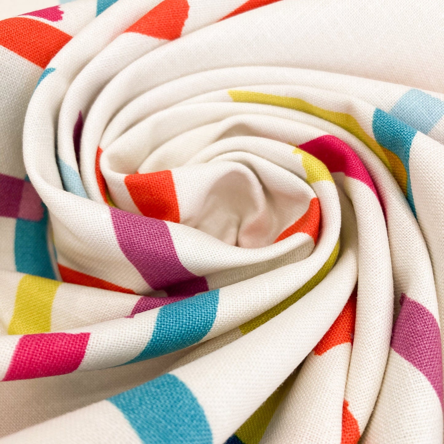 Swirl of cream cotton & linen canvas fabric with washi tape print in bright colours.
