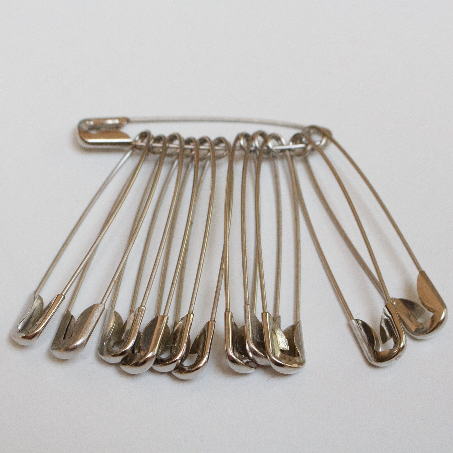 A bunch of 12 safety pins - 50mm, nickel