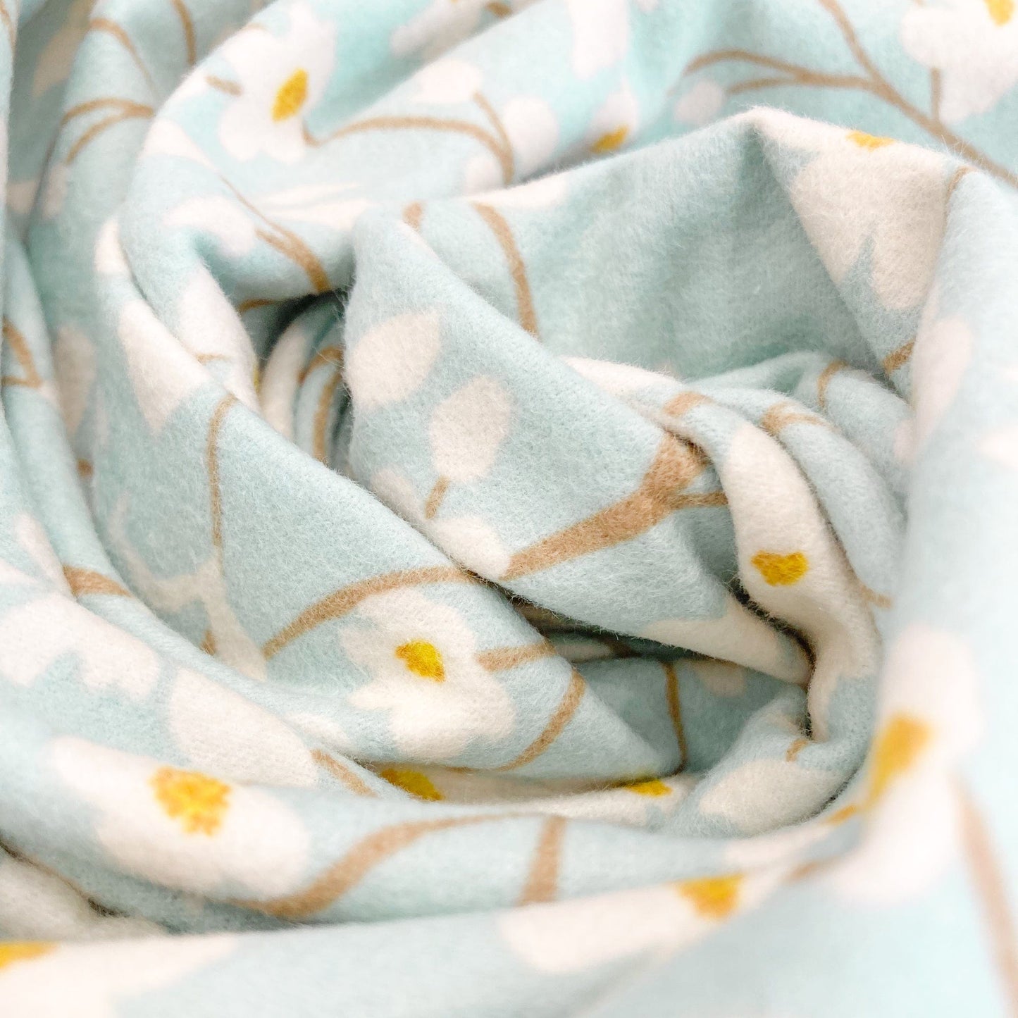 Light blue brushed cotton fabric with floral pattern.