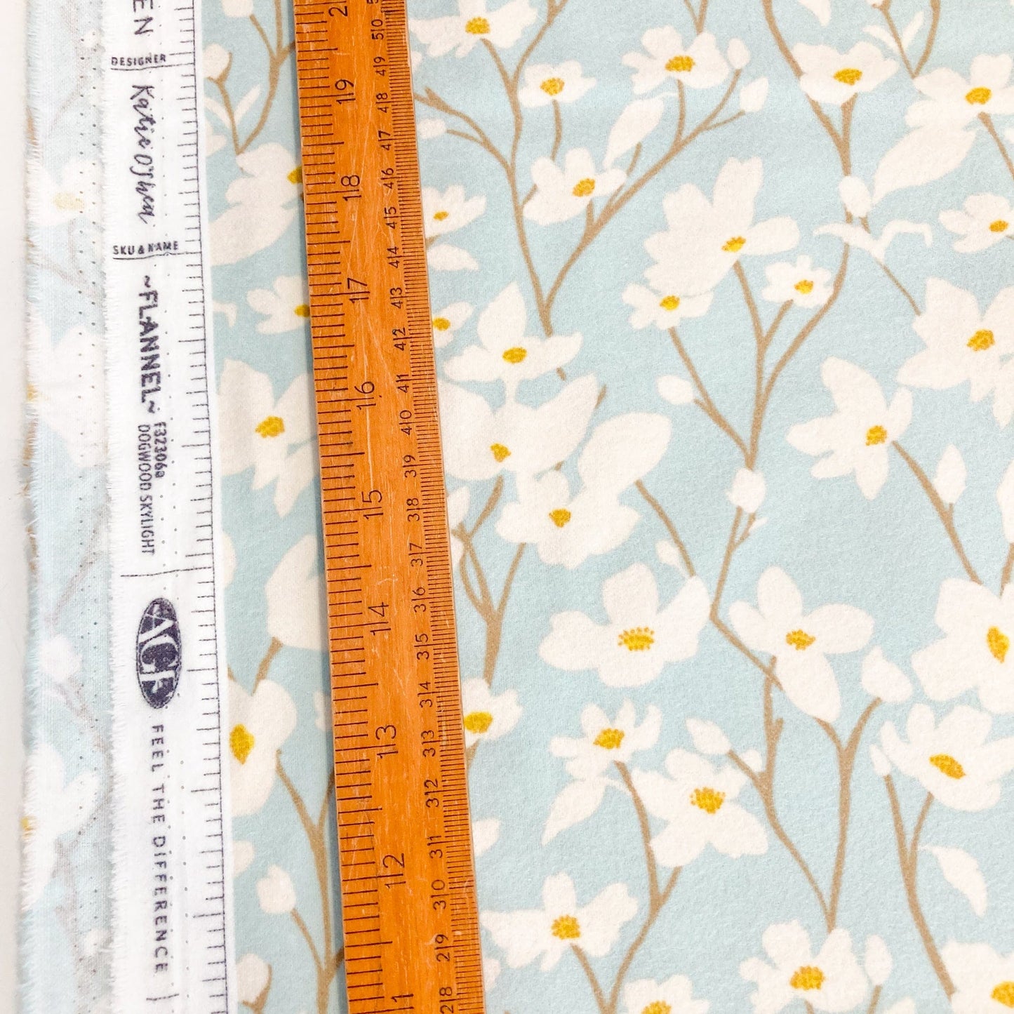 Floral brushed cotton fabric with a ruler for scale