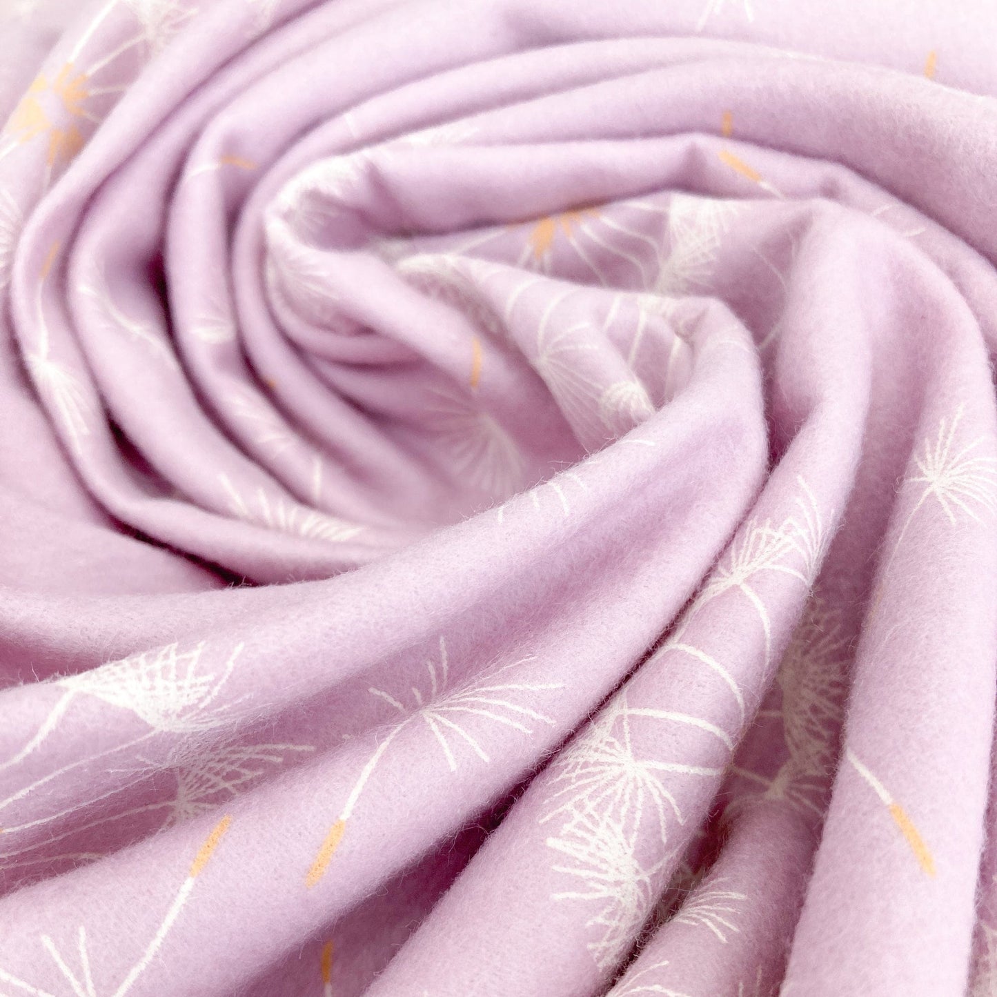 Swirl of lilac brushed cottonfabric with dandelion pattern