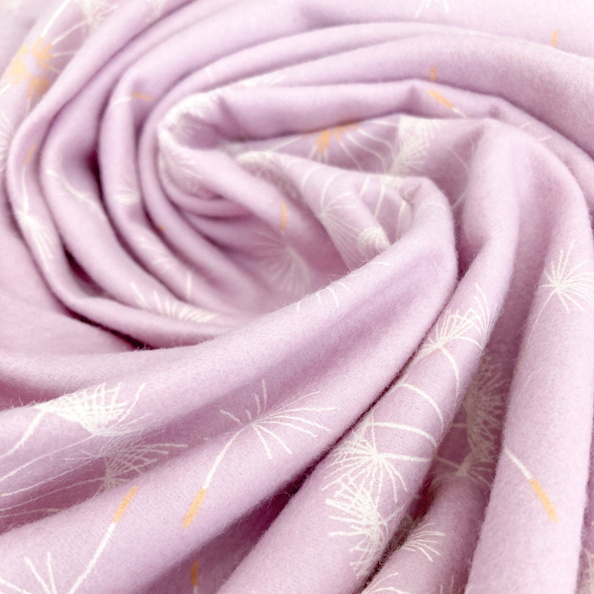 Swirl of lilac brushed cottonfabric with dandelion pattern