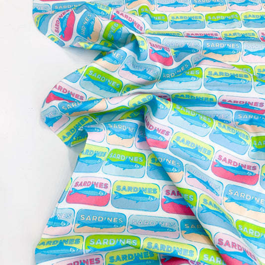Quilting cotton with colorful pop-art style sardine tin pattern on a white background