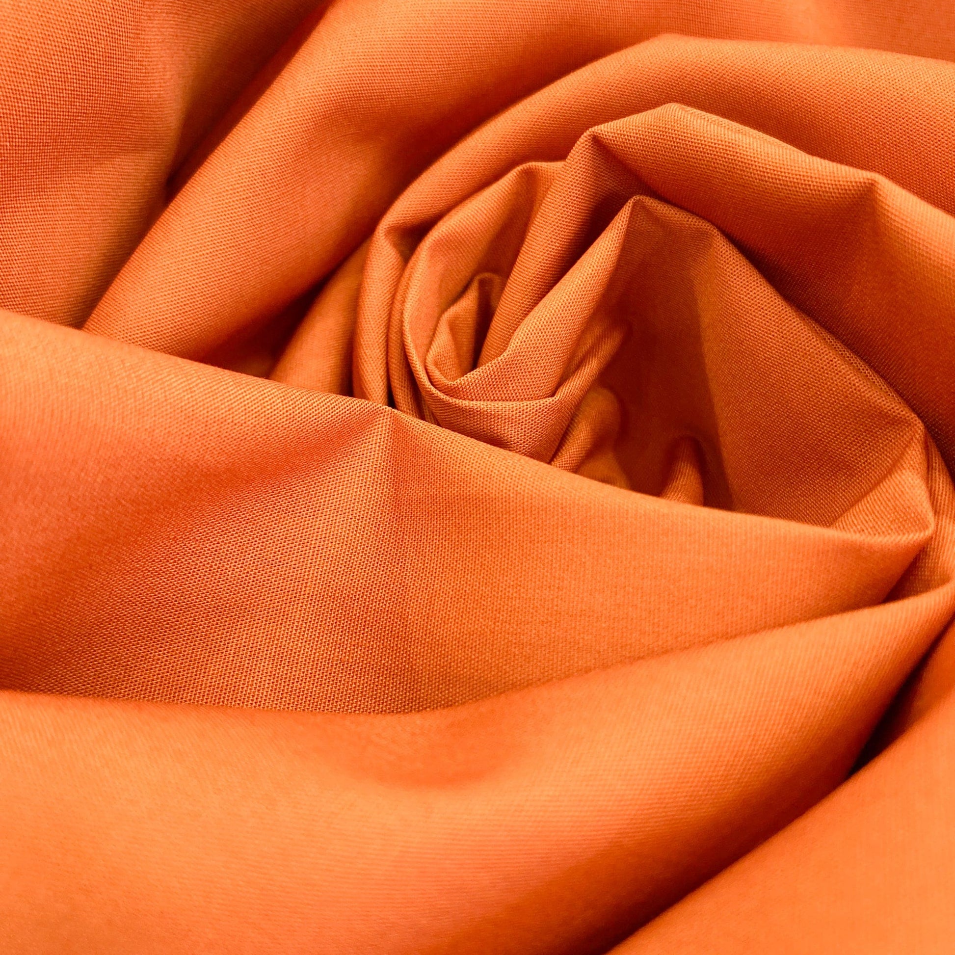 Close-up of Art Gallery Fabrics burnt orange quilting cotton solid