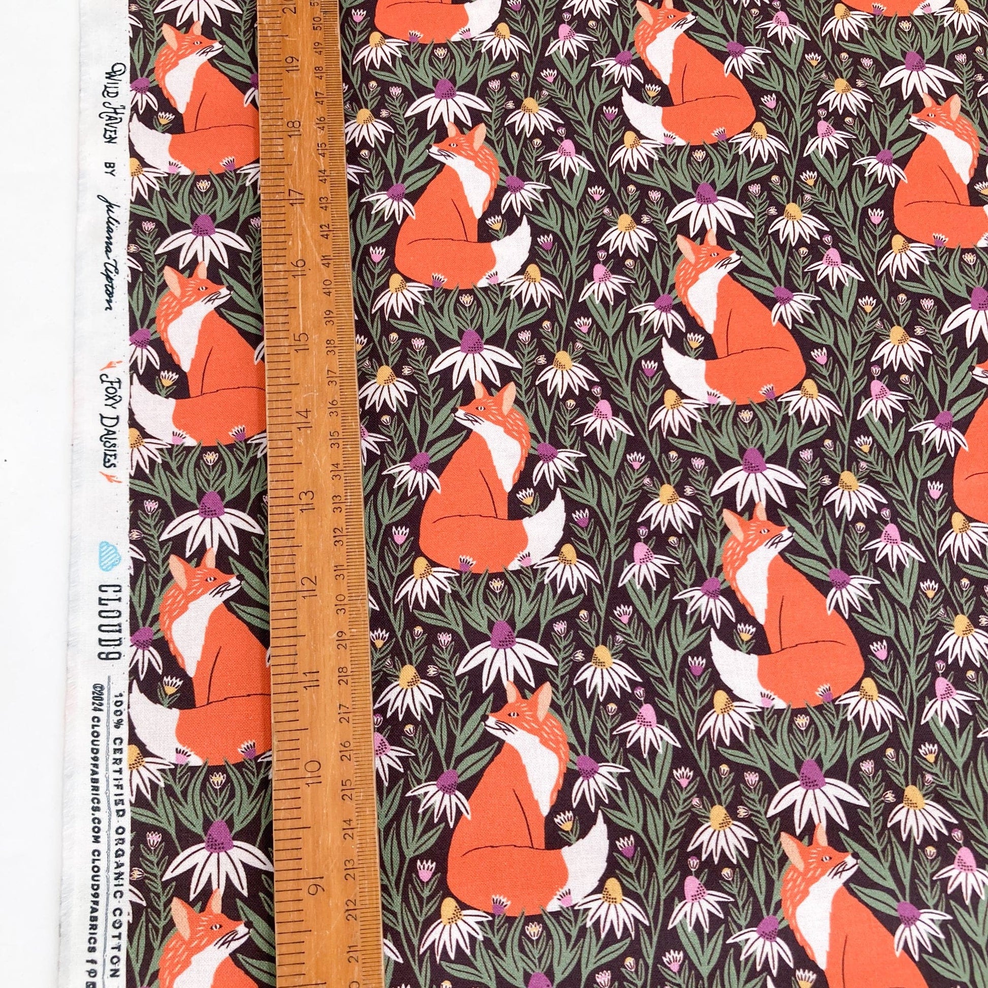 Organic quilting cotton with fox and floral pattern.and a ruler for scale