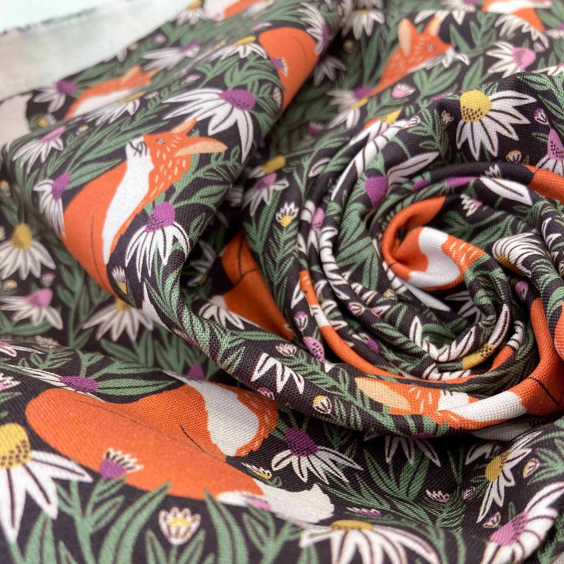 Swirl of organic quilting cotton with fox and floral pattern.