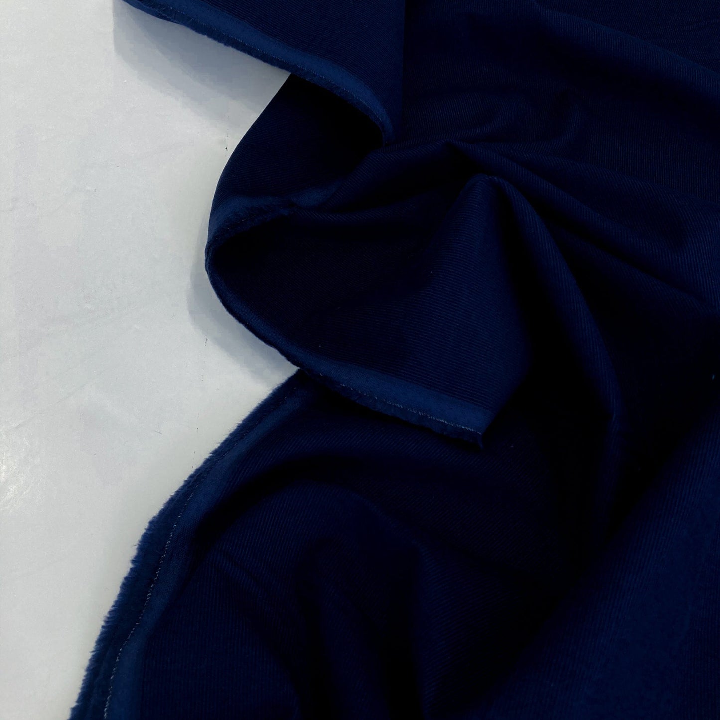 Navy blue cotton needlecord on a white background