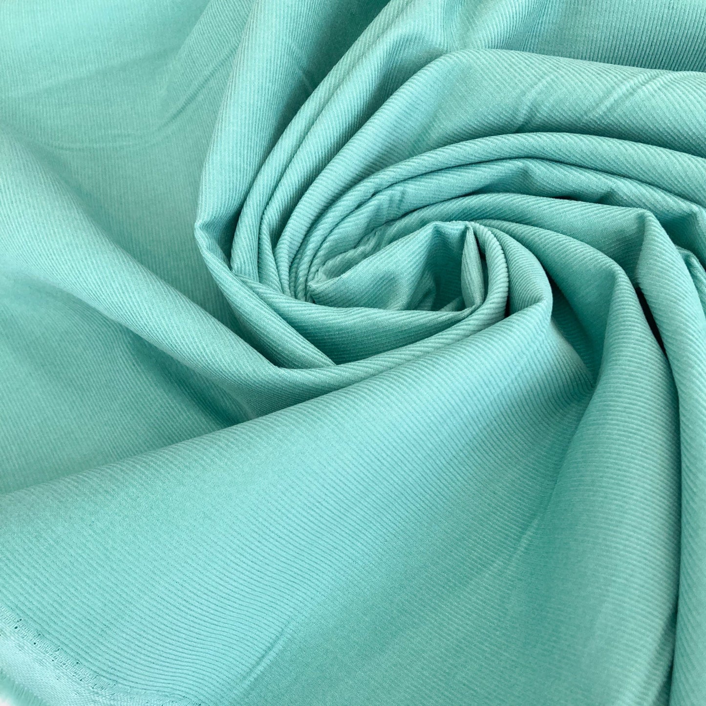 Close-up of swirled turquoise cotton needlecord fabric