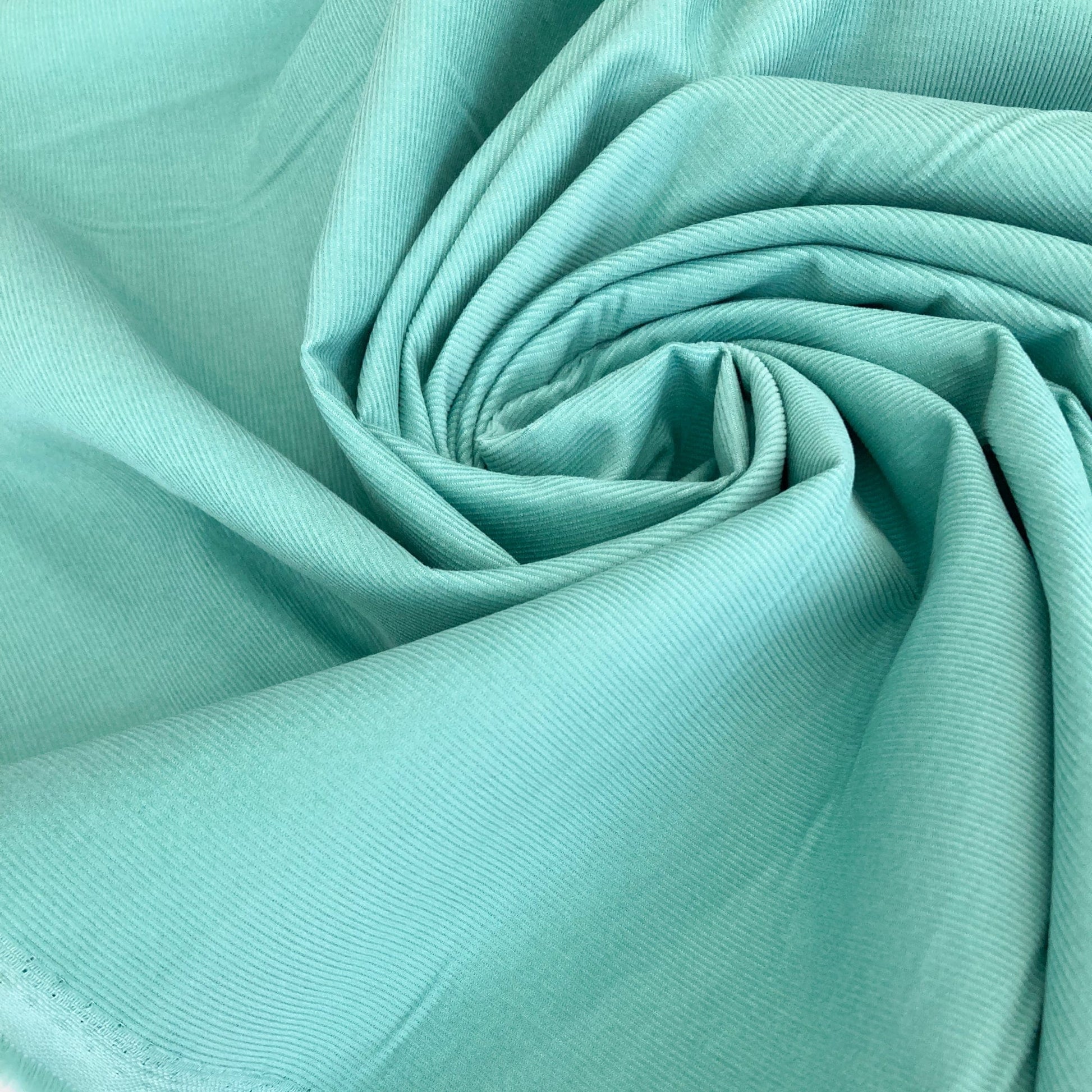 Close-up of swirled turquoise cotton needlecord fabric