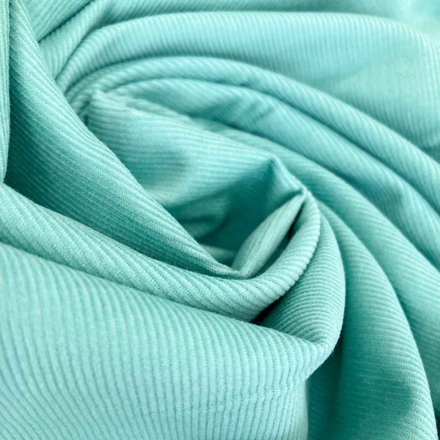 Close-up of turquoise cotton needlecord fabric