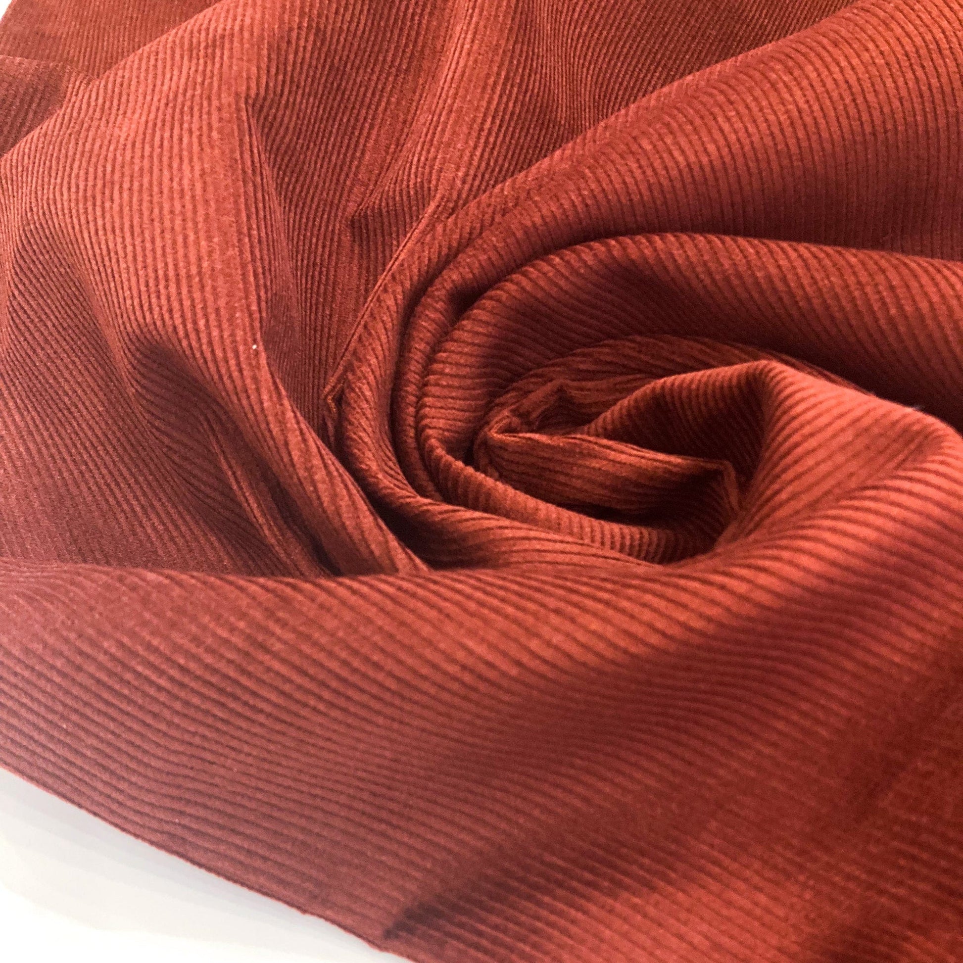 Close-up of a swirl of brown corduroy fabric