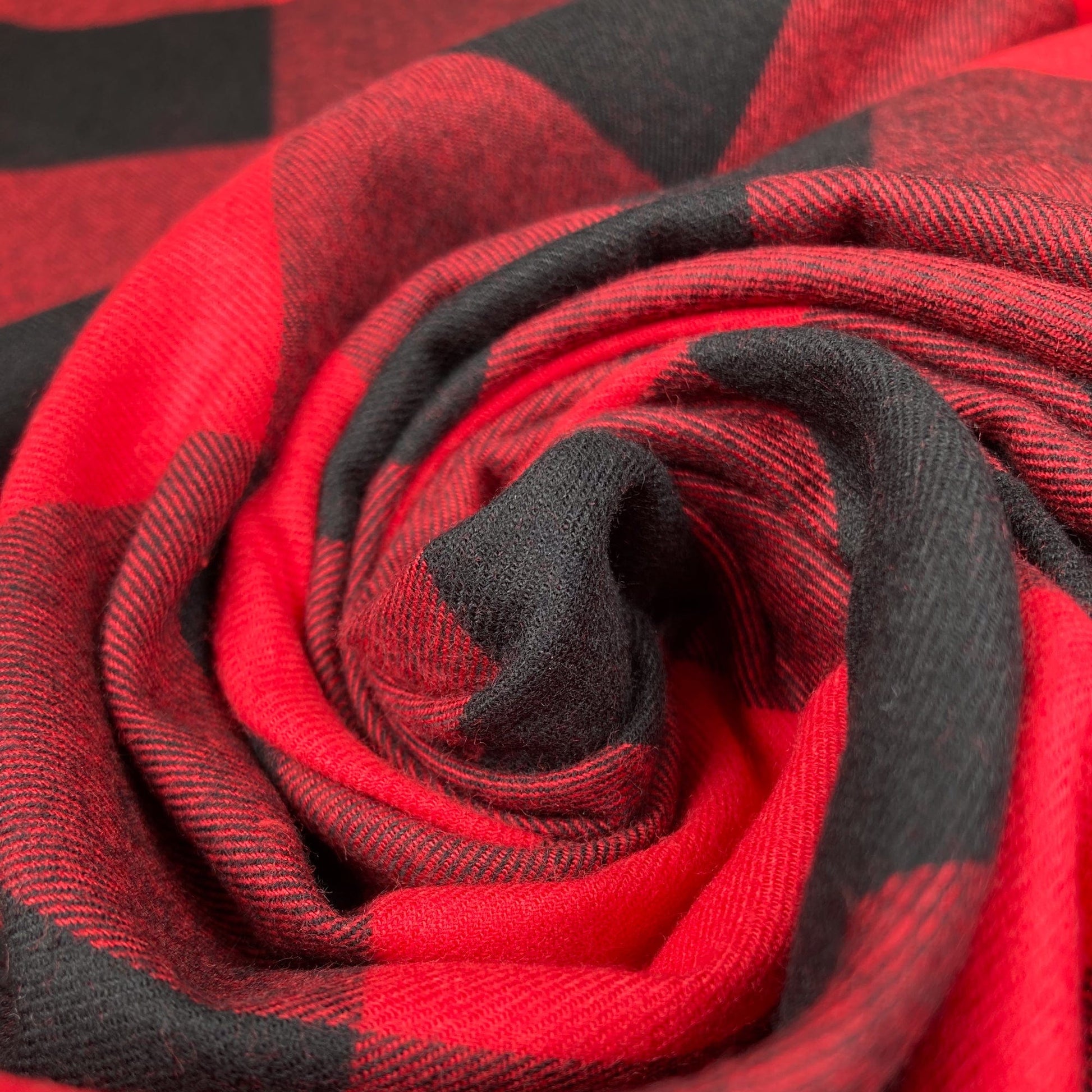 Swirl of red and black buffalo check flannel twill