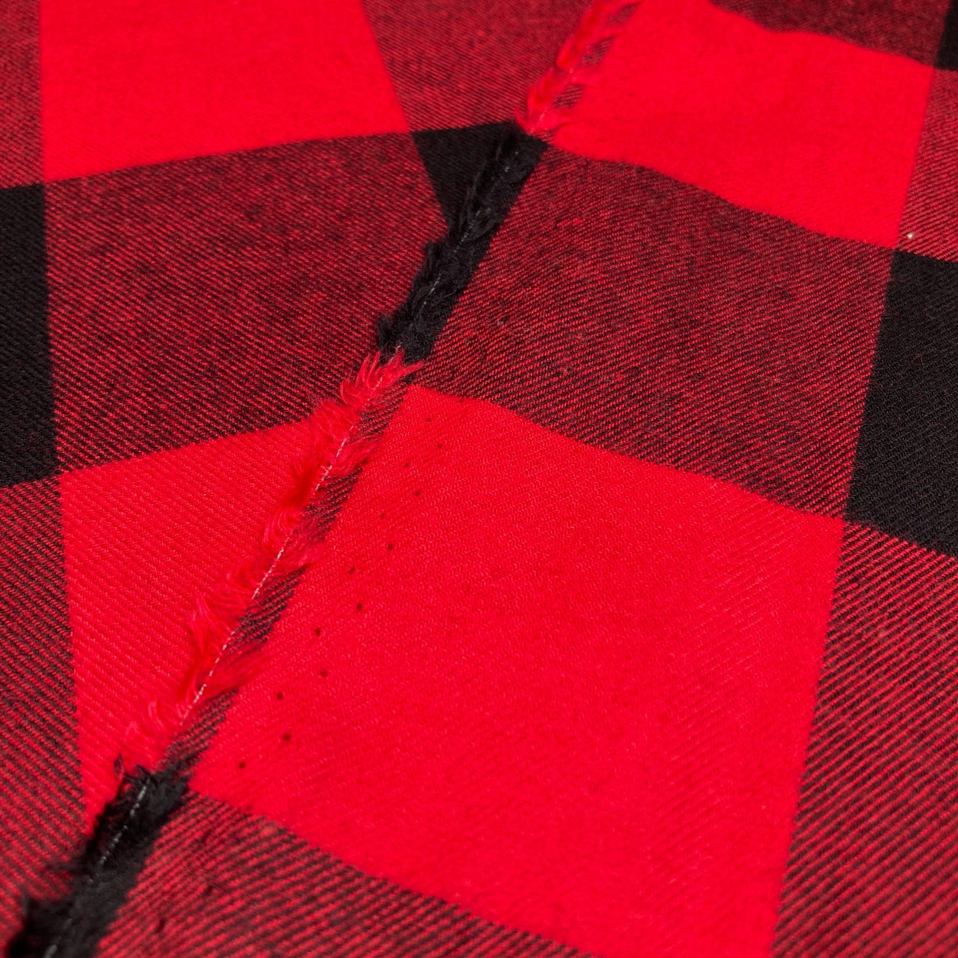 Close-up showing the front and back of buffalo check flannel twill in red and black
