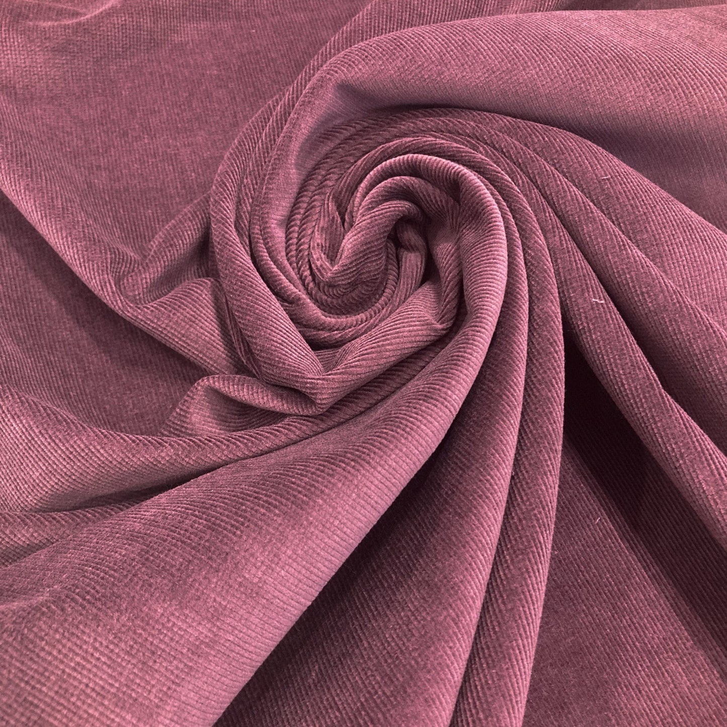 Close-up of swirled purple corduroy  fabric