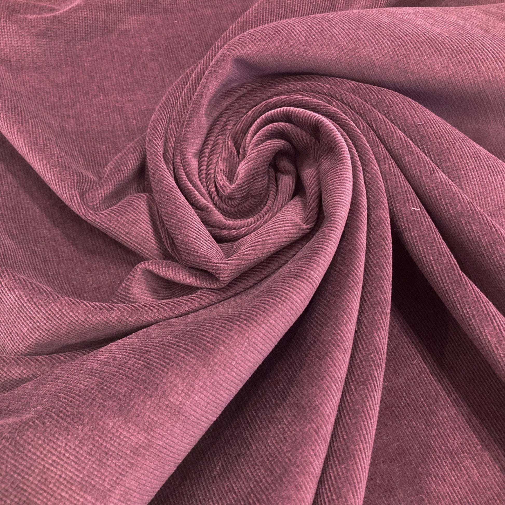Close-up of swirled purple corduroy  fabric