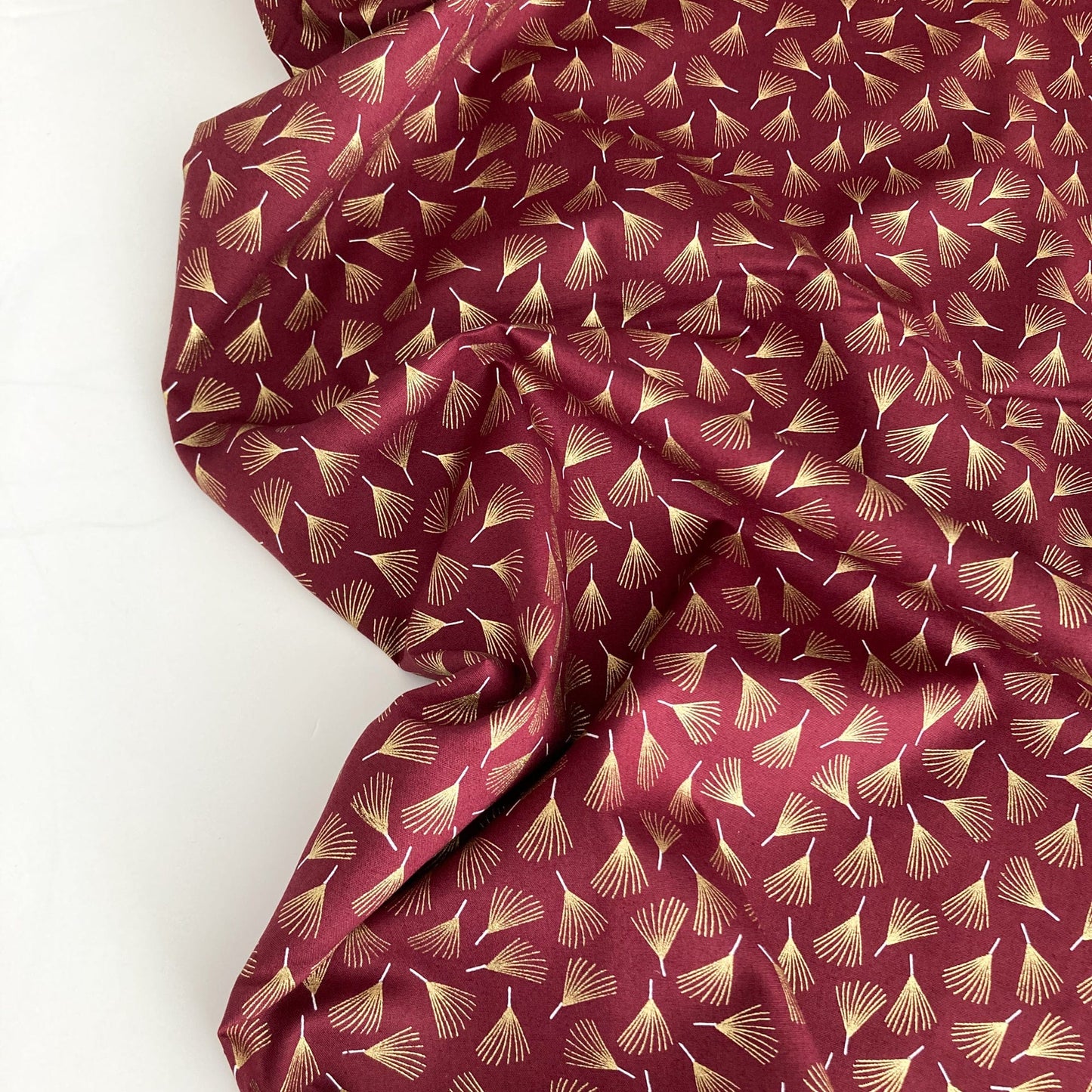 Cotton Fabric in Burgundy with Metallic Pine Leaf Print