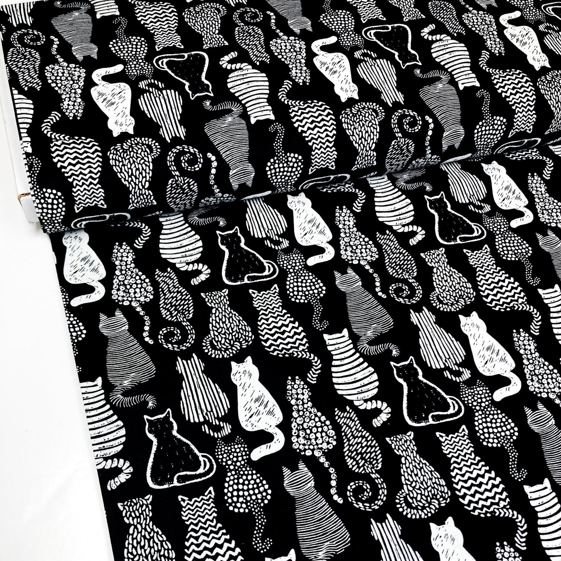 Cotton Fabric with a graphic style cat print in black and white.