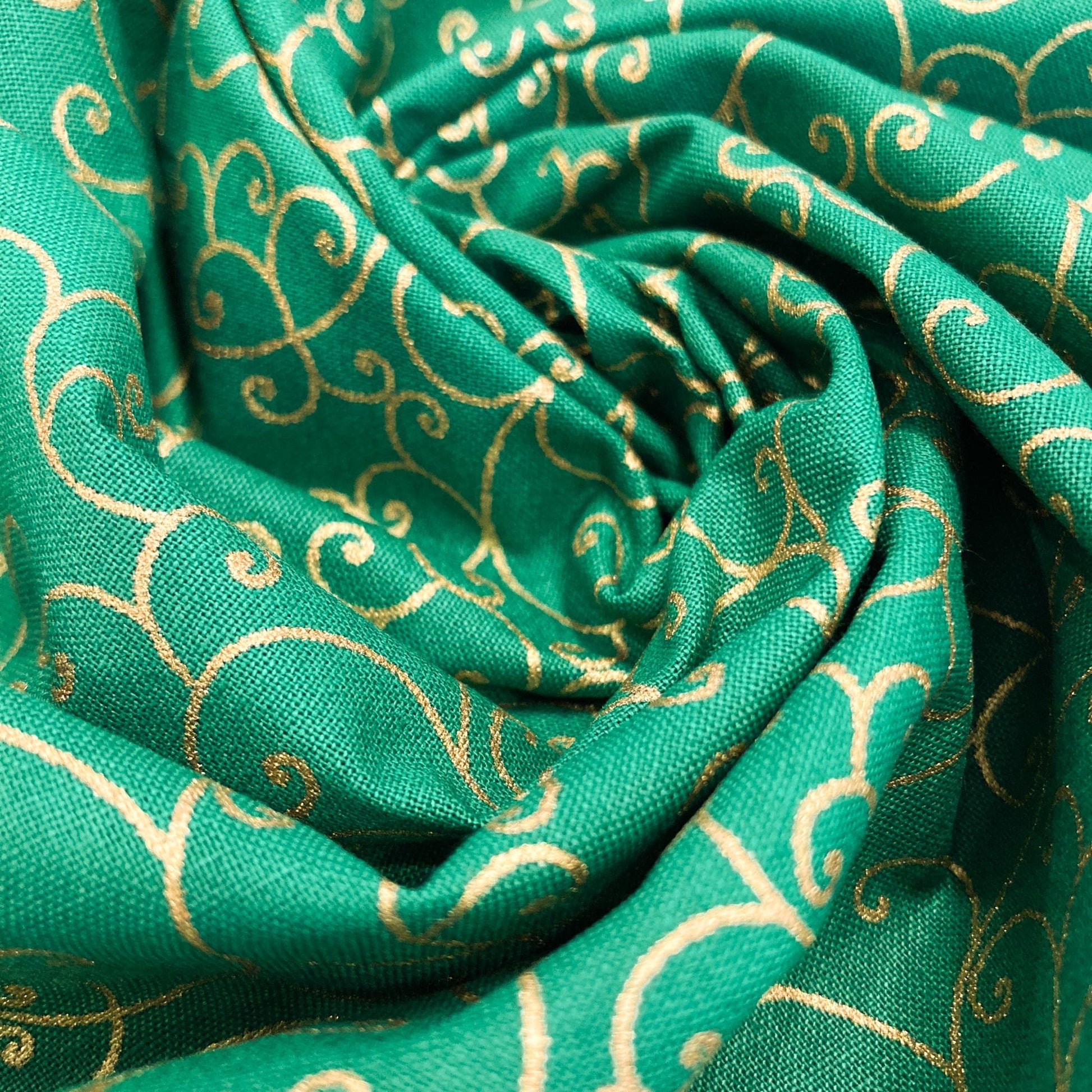 Swirl of green quilting cotton with celtic style metallic gold swirl pattern