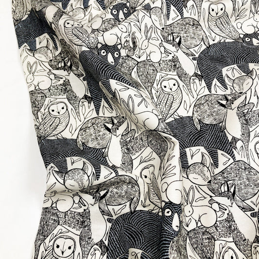 Black and white patterned cotton fabric with animal illustrations