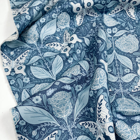 Blue cotton fabric with white butterfly and floral pattern