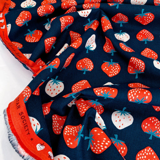 Fabric with strawberry pattern on a blue background