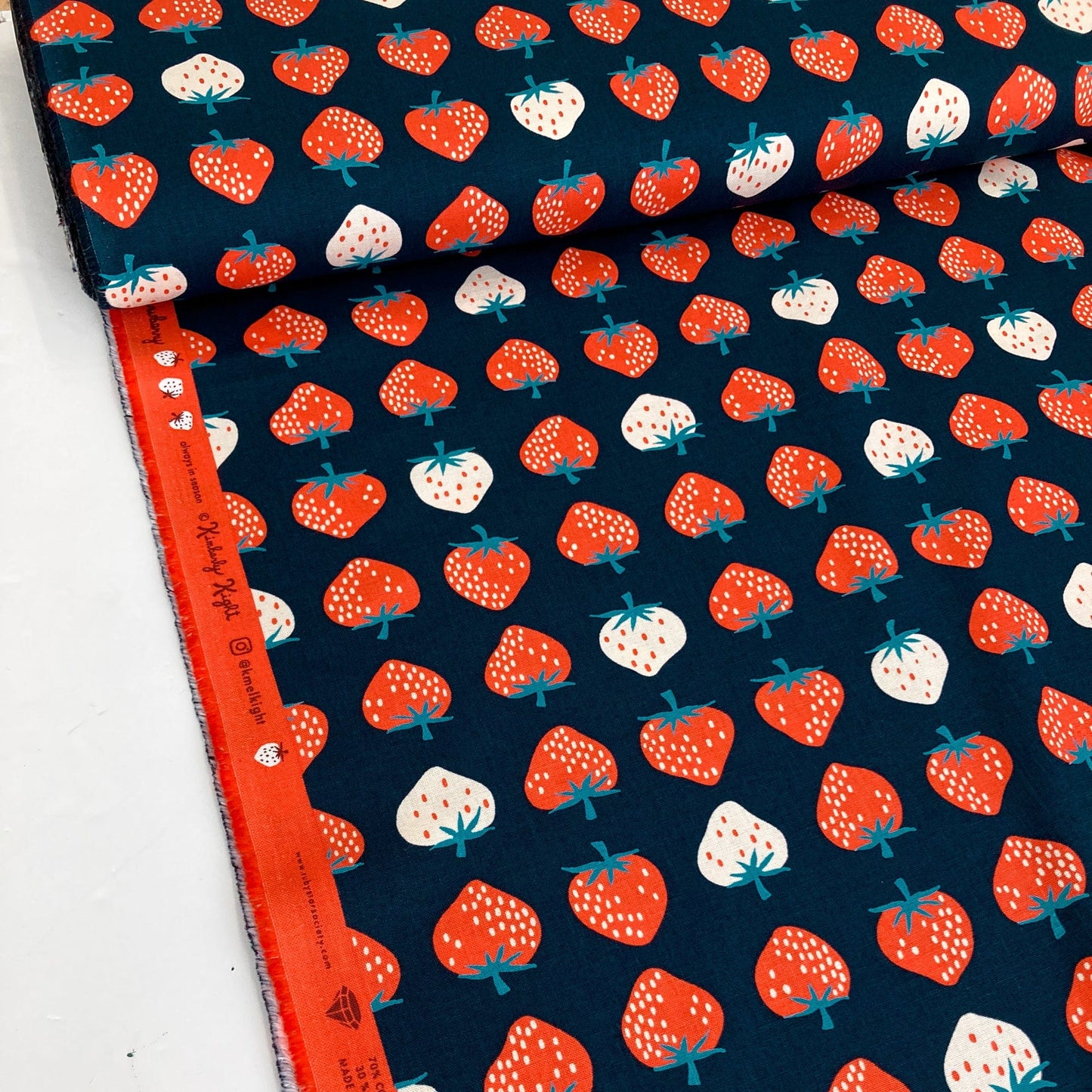 Fabric with strawberry pattern on a blue background