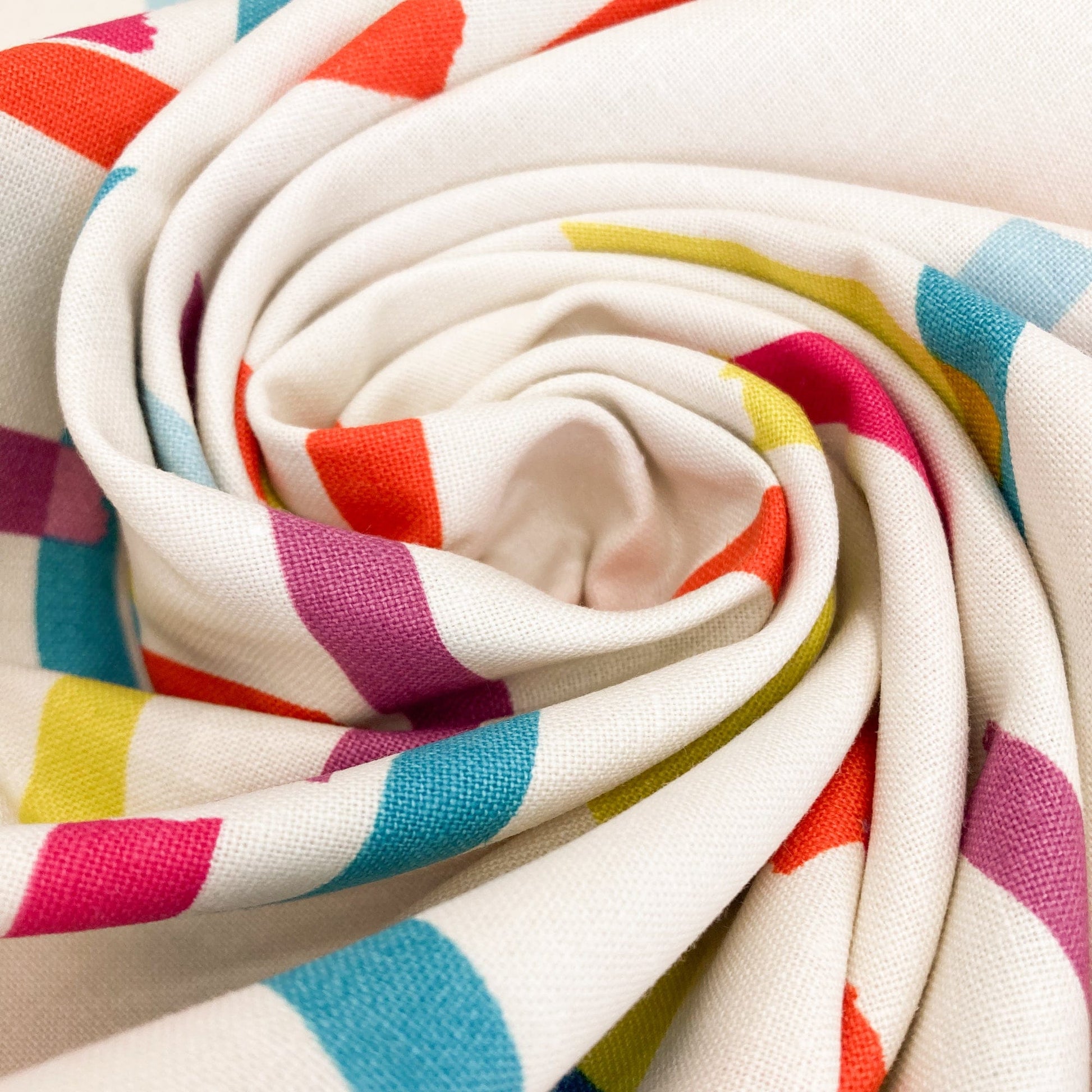 Swirl of cream cotton & linen canvas fabric with washi tape print in bright colours.