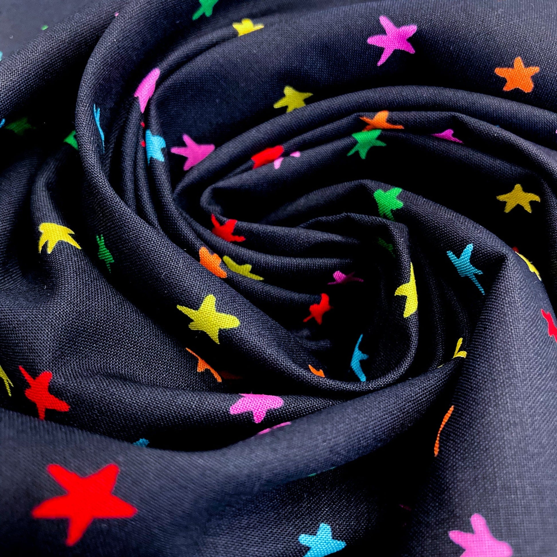 Swirl of black quilting cotton with colorful star pattern
