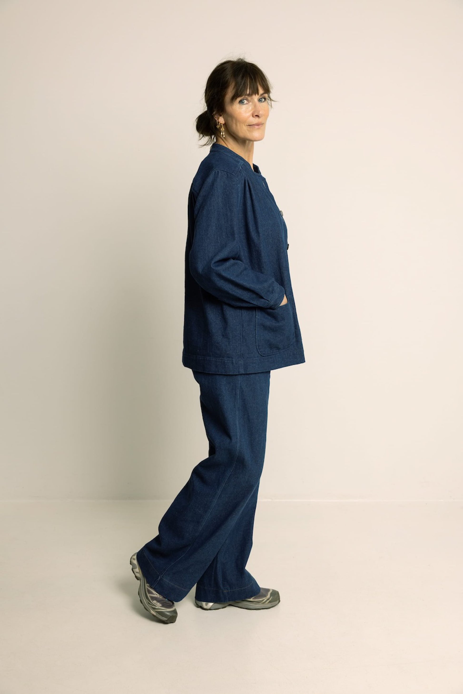 Person wearing a blue outfit on a plain background