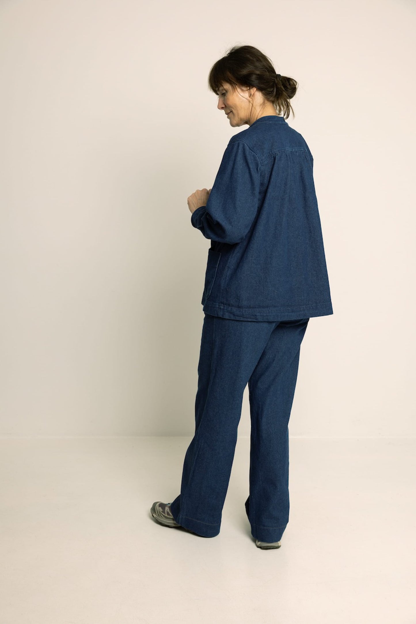 Person wearing a blue outfit on a plain background