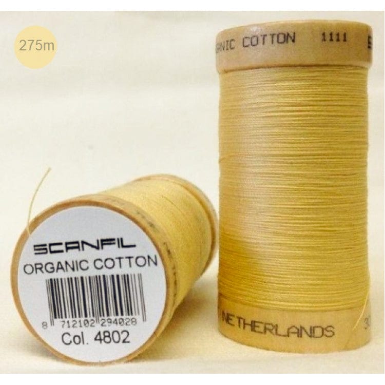 two wooden reels of light mustard yellow organic cotton sewing thread